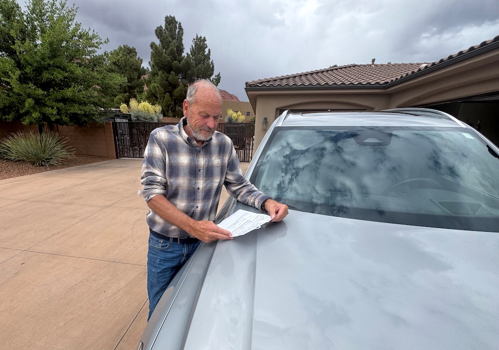(Mark Eddington | The Salt Lake Tribune) Jack Hoopes examines the citation he received for honking his horn during the March 28 No Kings protest in St. George.