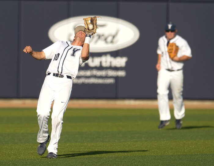 (Leah Hogsten  |  The Salt Lake Tribune) BYU's shortstop Daniel Schneemann pulls down the out as Brigham Young University hosts University of Utah at Miller Park, Tuesday, April 24, 2018 in Provo.