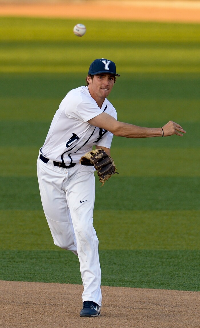 (Leah Hogsten  |  The Salt Lake Tribune) BYU's Daniel Schneemann throws to first to out Utah's Shea Kramer as Brigham Young University hosts University of Utah at Miller Park, Tuesday, April 24, 2018 in Provo.
