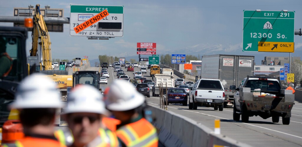 Al Hartmann  |  The Salt Lake Tribune
With 150 road projects for 2016, UDOT is encouraging safe driving around construction areas. Cars go by at over 70 mph near road construction between 12300 South and Bangerter Highway exits on I-15 Tuesday, April 12.  Often orange barrels or a concrete barrier is the only thing protecting road workers from traffic passing by only 3 feet away.