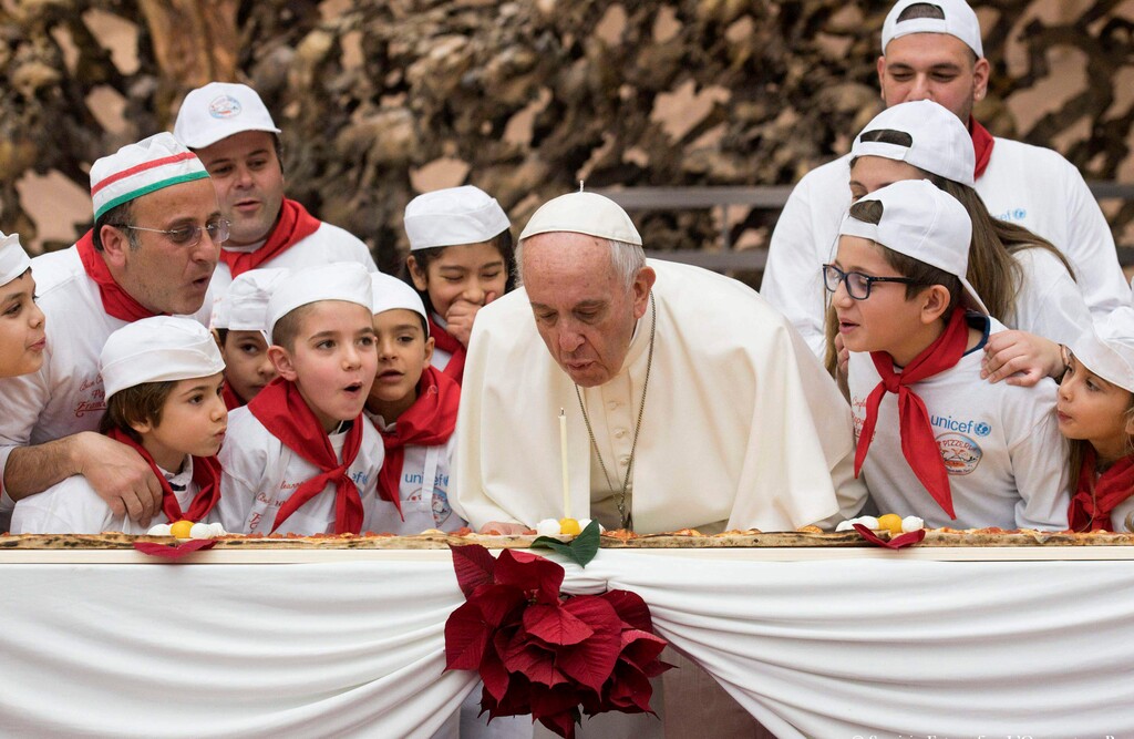 (L'Osservatore Romano/Pool Photo via AP) Pope Francis blows a candle on the occasion of his 81st birthday during a private audience with children the Paul VI hall at the Vatican, Sunday, Dec. 17, 2017.