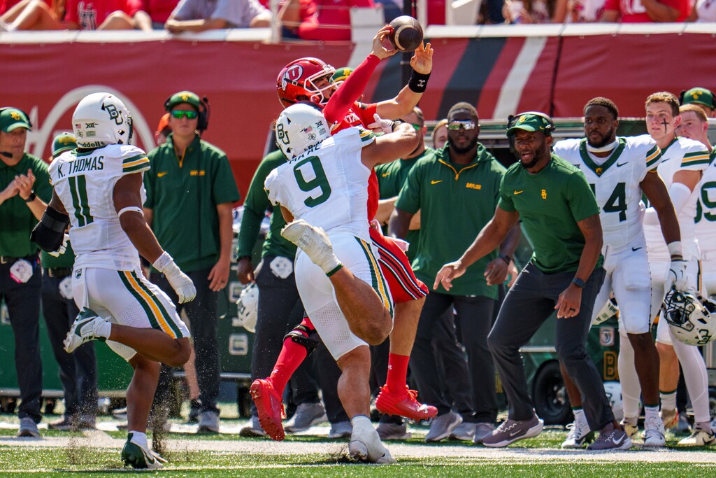 (Trent Nelson | The Salt Lake Tribune) Utah Utes quarterback Cameron Rising (7) throws the ball away as he's run out of bounds by Baylor Bears defensive lineman Treven Ma'ae (9) as the Utah Utes host the Baylor Bears, NCAA football in Salt Lake City on Saturday, Sept. 7, 2024.