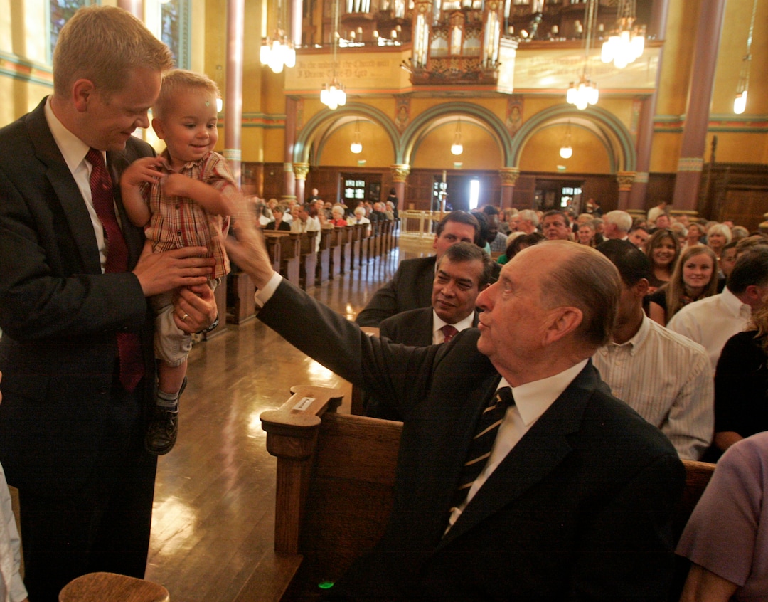 (Tribune file photo) President Thomas S. Monson visits with Scott Daw of Herriman and Daw's 1-year-old son, Brennan Daw during an event at the Cathedral of the Madeleine in August 2012.