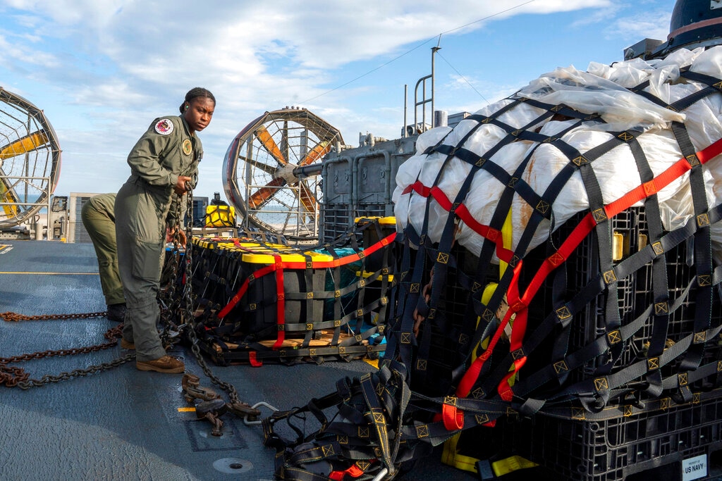 (Ryan Seelbach | U.S. Navy via AP) In this image released by the U.S. Navy, sailors assigned to Assault Craft Unit 4 prepare material recovered off the coast of Myrtle Beach, S.C., in the Atlantic Ocean from the shooting down of a Chinese high-altitude balloon, for transport to the FBI, at Joint Expeditionary Base Little Creek in Virginia Beach, Va., on Feb. 10, 2023. The federal government's lack of information about four aerial objects recently shot down over North America is helping to fuel conspiracy theories and conjecture on the internet.