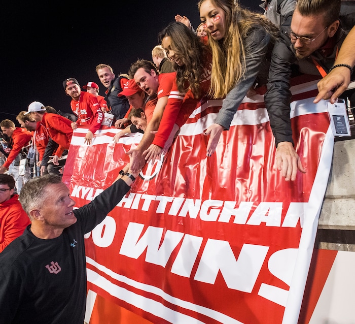 (Rick Egan | The Salt Lake Tribune) Kyle Whittingham high-fives fans after his 100th win as Utah's head coach in 2016.