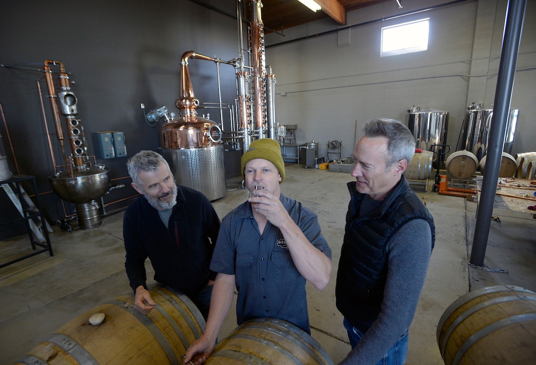 (Al Hartmann  |  The Salt Lake Tribune) 	
Matt Aller, left, Chris Barlow, and Erik Ostling, co-owners of Beehive Distilling sample Barrel Reserve Gin at their new Salt Lake City location, 2245 S. West Temple. The new 450-gallon copper still in the background will allow for increased production.