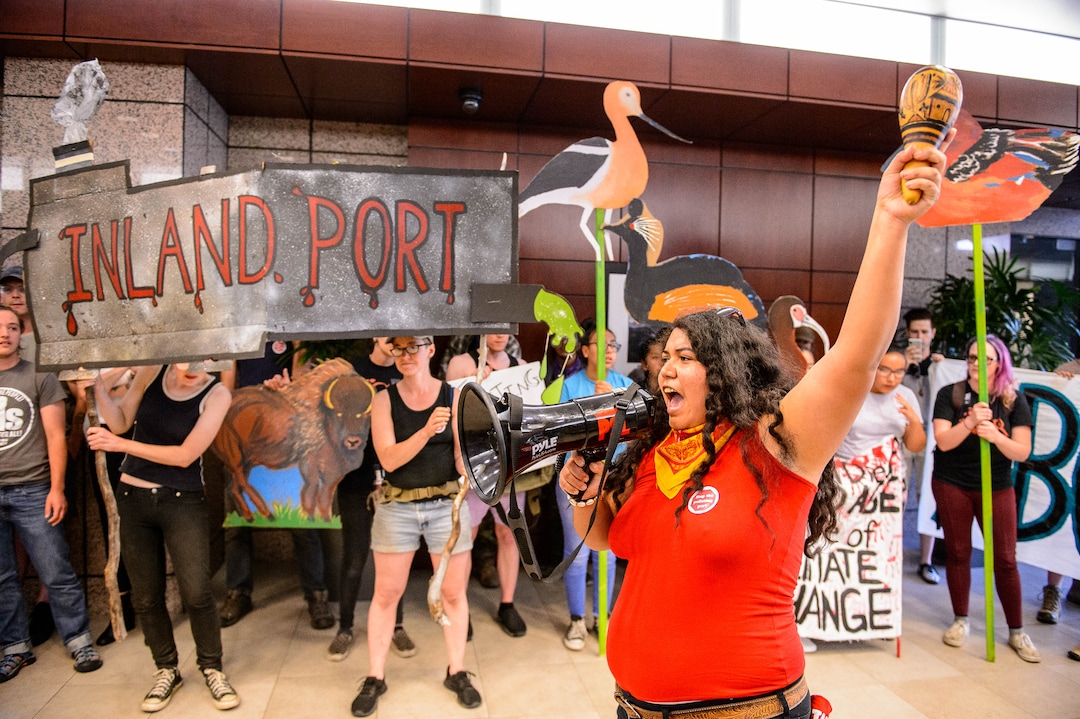 (Trent Nelson  |  The Salt Lake Tribune)  Protesters occupy the lobby of the Chamber of Commerce Building in Salt Lake City on Tuesday, July 9, 2019. Dozens of people showed up to protest the proposed Inland Port and ended up clashing with police, resulting in temporary street closures and arrests.