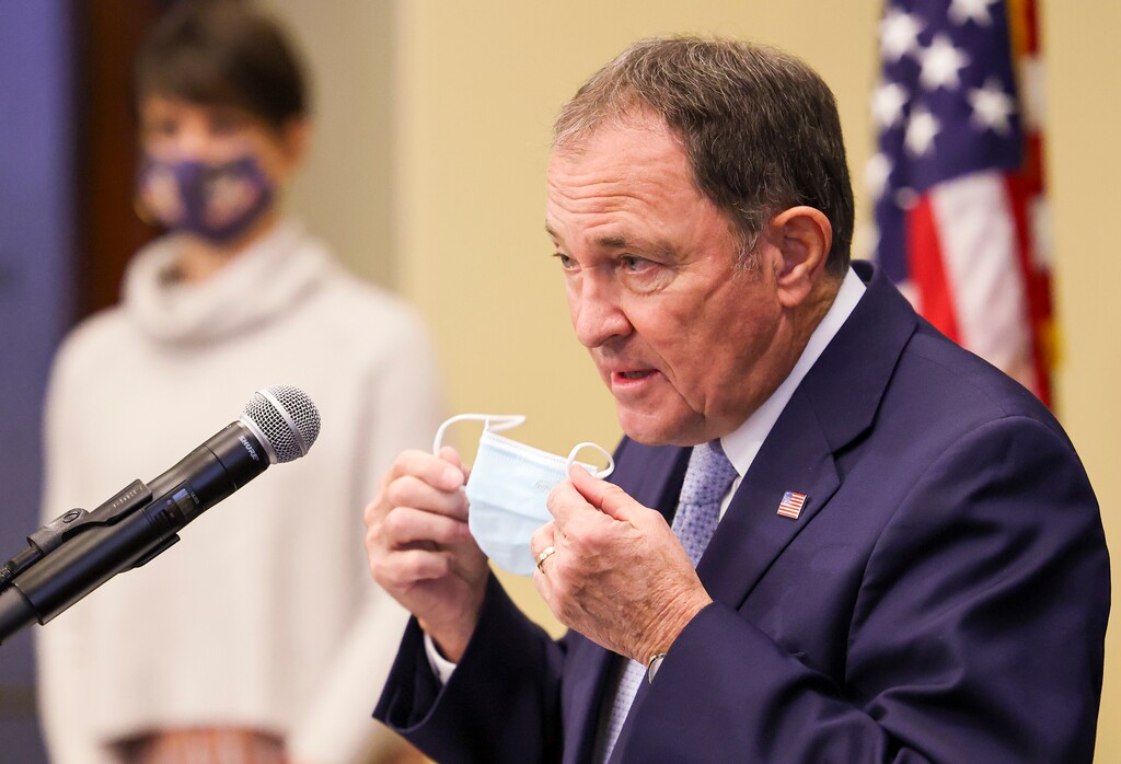 (Scott G Winterton | Deseret News, pool) Utah Gov. Gary Herbert takes off his mask as he joins state epidemiologist Dr. Angela Dunn at a press conference at the Capitol in Salt Lake City, clarifying the state's mask mandate on Monday, Nov. 9, 2020.