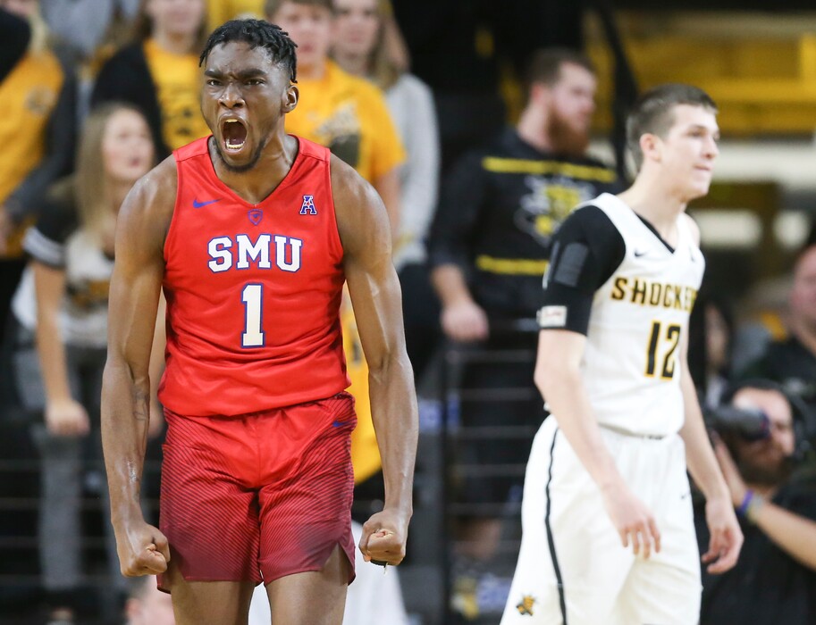SMU guard Shake Milton celebrates a shot and a foul while Wichita State guard Austin Reaves can only watch during the second half of an NCAA college basketball game, Wednesday, Jan. 17, 2018 in Wichita, Kan. (Travis Heying/The Wichita Eagle via AP)