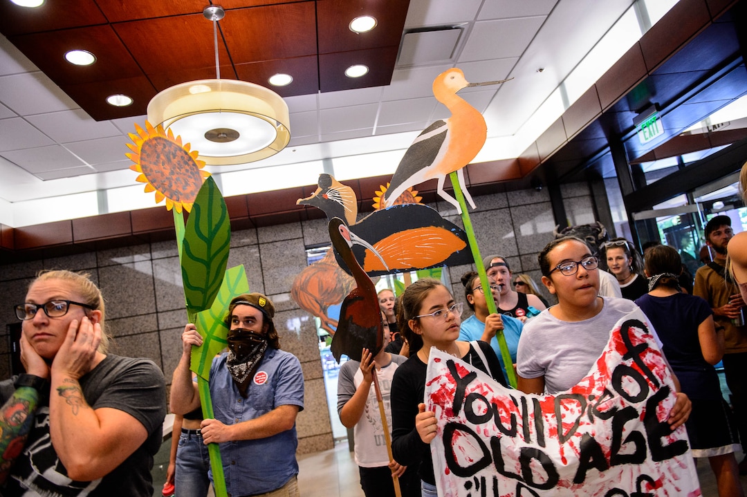(Trent Nelson  |  The Salt Lake Tribune) People protesting the planned Inland Port occupy the lobby of the Chamber of Commerce Building in Salt Lake City on Tuesday, July 9, 2019.