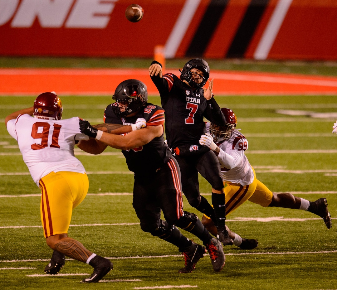 (Trent Nelson  |  The Salt Lake Tribune) Utah Utes quarterback Cameron Rising (7) throws the ball as he's hit as the Utah Utes host the USC Trojans, NCAA football at Rice-Eccles Stadium in Salt Lake City on Saturday, Nov. 21, 2020.
