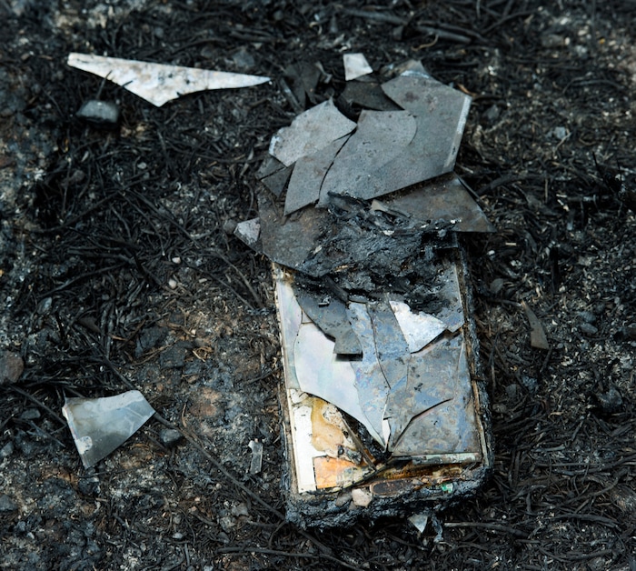 (Rick Egan  |  The Salt Lake Tribune)        A smart phone burned in the Dollar Ridge Fire, Tuesday, July 10, 2018.


