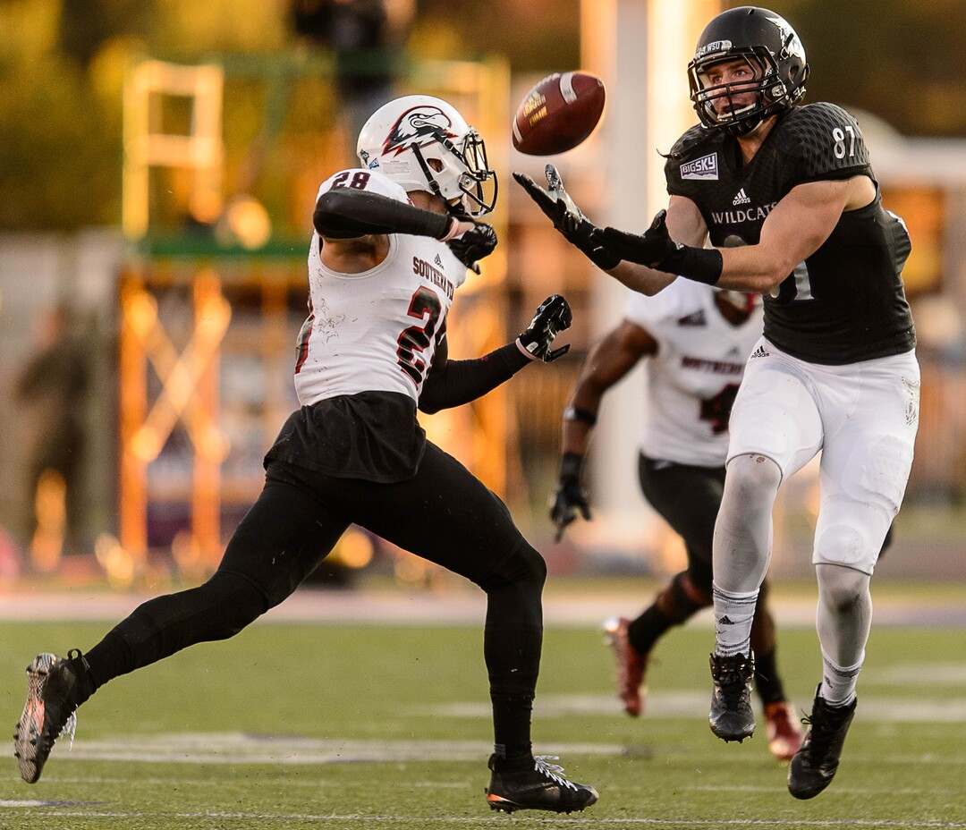 (Trent Nelson | The Salt Lake Tribune)  Weber State Wildcats tight end Andrew Vollert (87) pulls in a pass ahead of Southern Utah Thunderbirds safety Alex Sims (28) as Weber State hosts Southern Utah, NCAA football in Ogden Saturday October 14, 2017.