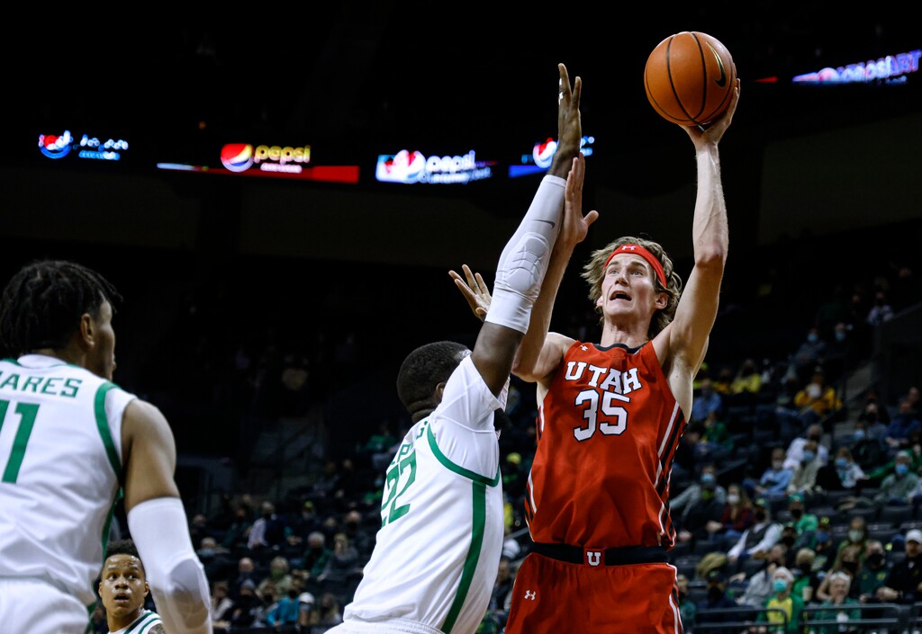 (Thomas Boyd | AP) Utah center Branden Carlson (35) shoots over Oregon center Franck Kepnang (22) during the second half of an NCAA college basketball game in Eugene, Ore., Saturday.
