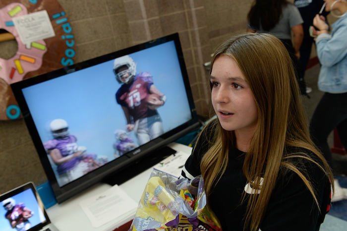 (Francisco Kjolseth | The Salt Lake Tribune) Sam Gordon, 14, works her fellow students at Herriman High School in an effort to sign up girls to play football during a recent clubs sign up day. Brent Gordon and his daughter, Sam, are part of a group suing multiple school districts to try to force the creation of sanctioned girls high school football that would play in the Spring.