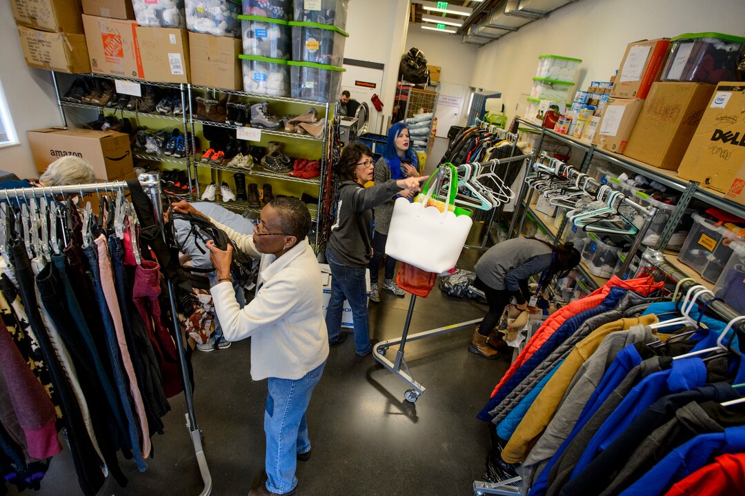 (Steve Griffin  |  The Salt Lake Tribune)  Volunteers at Volunteers of America sort clothing that has been donated to help homeless young people in Salt Lake City Monday December 11, 2017.