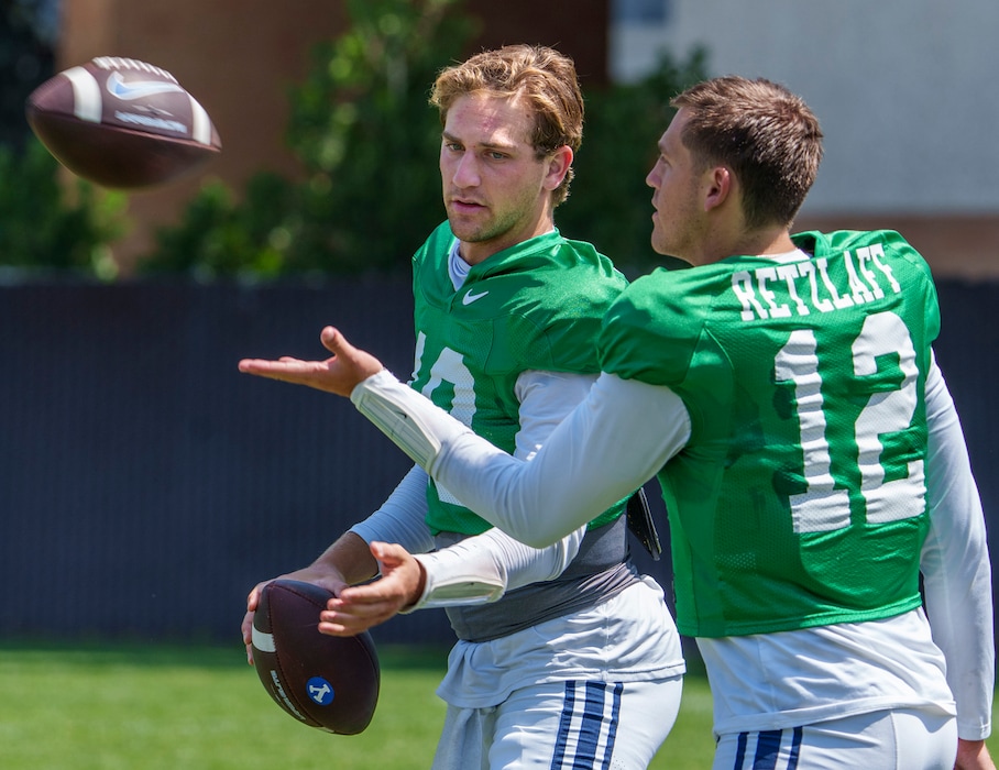 (Leah Hogsten | The Salt Lake Tribune) Brigham Young University starting quarterback Kedon Slovis, left, throws passes with backup quarterback Jake Retzlaff during football practice Aug. 8, 2023 in Provo. 