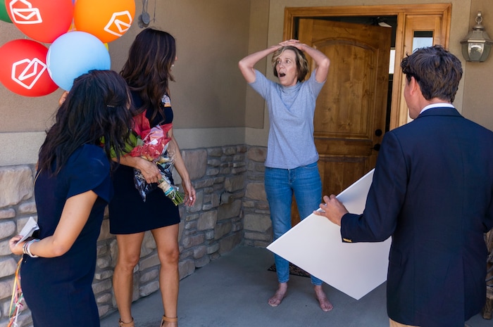 (Rick Egan | The Salt Lake Tribune) Members of the Prize Patrol from Publishers Clearing House, from left,  Bianca Quinnonez, Danielle Lam and  Howie Guja surprise Denise Hagman (center) with the news that she and her husband won $1,000,000, at her home in Herriman, on Friday, May 28th