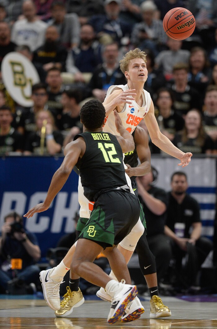 (Francisco Kjolseth  |  The Salt Lake Tribune)  Syracuse Orange forward Marek Dolezaj (21) loses momentary control of the ball as Baylor Bears guard Jared Butler (12) gets a hand on the ball as Syracuse faces Baylor in their first round menÕs NCAA March Madness tournament game at Vivint Smart Home Arena in Salt Lake City on Thursday, March 21, 2019.