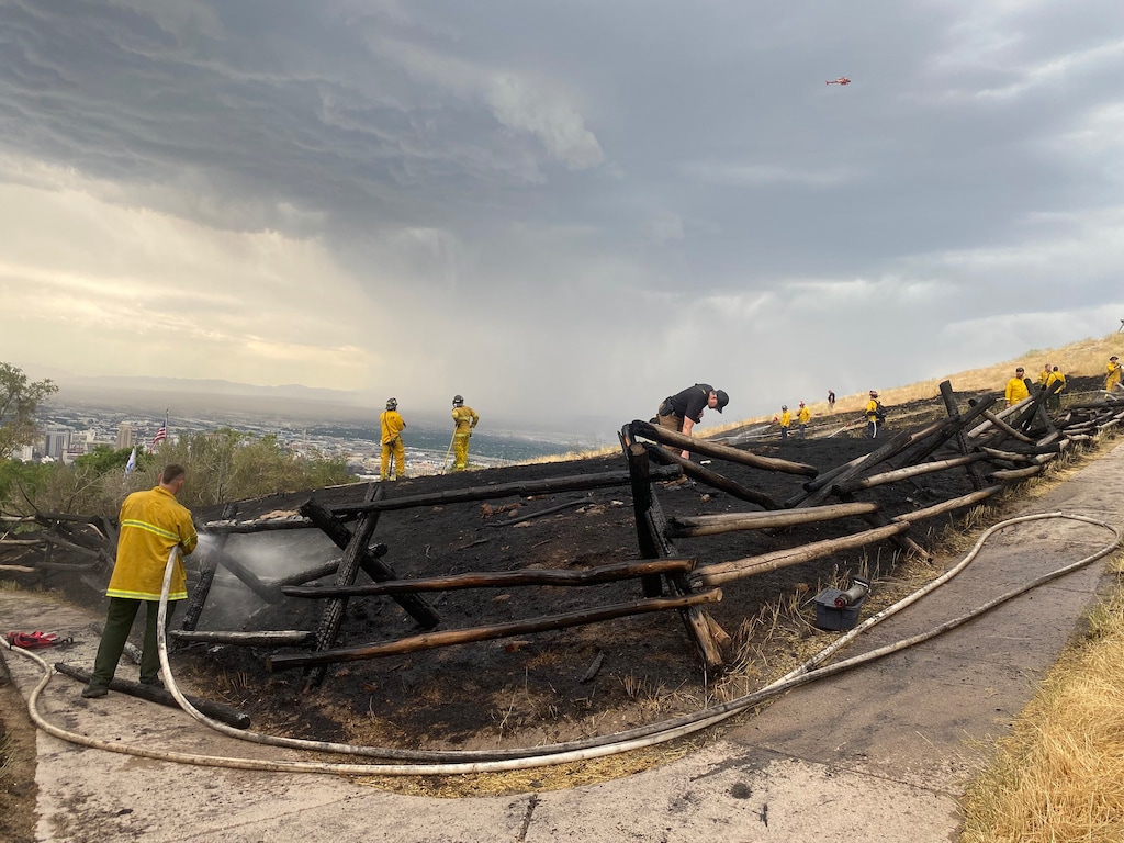 (Salt Lake City Fire Department) Crews from the Salt Lake City Fire Department mop up the remnants of a small grass fire near the Ensign Peak trailhead on July 2, 2025.