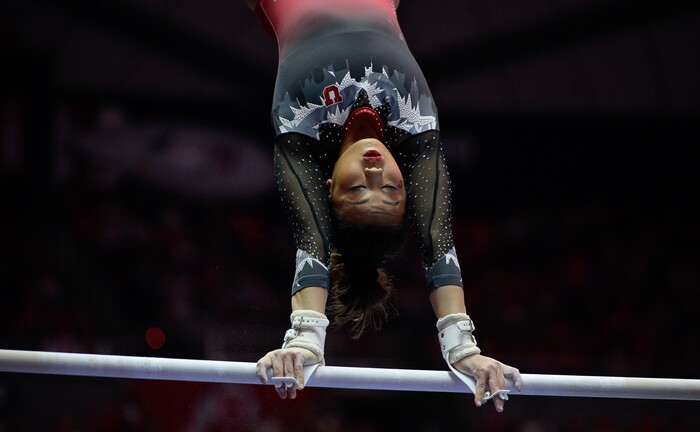 (Francisco Kjolseth  |  The Salt Lake Tribune)  Kari Lee performs her routine on the bars as Utah hosts Penn State in their season opener at the Huntsman Center in Salt Lake City on Saturday, Jan. 5, 2019.