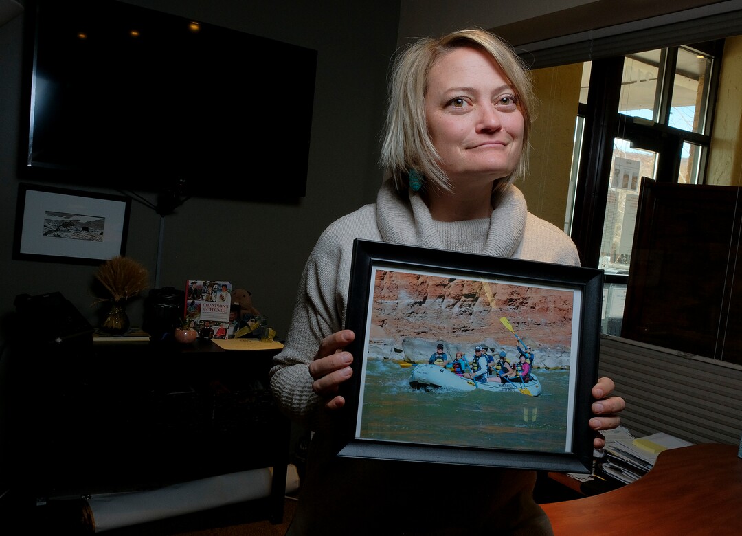 (Leah Hogsten | The Salt Lake Tribune) Moab Mayor Emily Niehaus found an ally in Sen. Mike McKell, R-Spanish Fork,  regarding UTV noise in Moab. Niehaus holds a photograph, of her guiding Senate President Stuart Adams, R-Layton, Sen. Jacob Anderegg, R-Lehi, his wife and two children and Sen. McKell and his wife Brandi down the Colorado River last fall. Niehaus has the on display at her city office, Feb. 19, 2021. McKell is sponsoring a bill that would allow Moab and other resort communities to adopt nighttime restrictions on off-highway vehicle traffic on city streets.