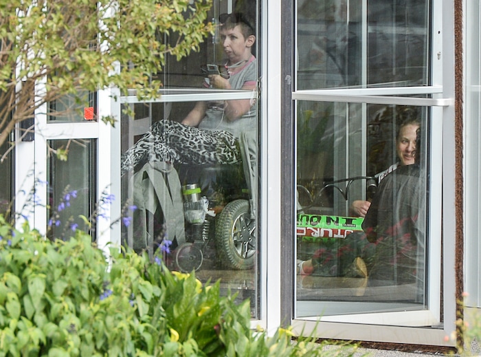 (Francisco Kjolseth  |  The Salt Lake Tribune)  Activists stage a protest against a private prison company with contracts to hold undocumented immigrants on Thursday, July 12, 2018, after locking themselves in the lobby at the headquarters of Management and Training Corporation in Centerville.