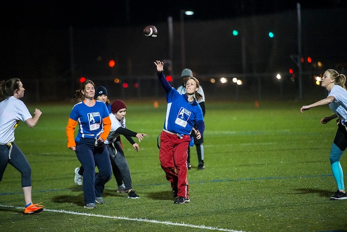 (Chris Detrick | The Salt Lake Tribune) Team A Lot quarterback Jenn Hartman throws the ball during the flag football team game against Sim Team at North University Fields in Provo Thursday, November 30, 2017.