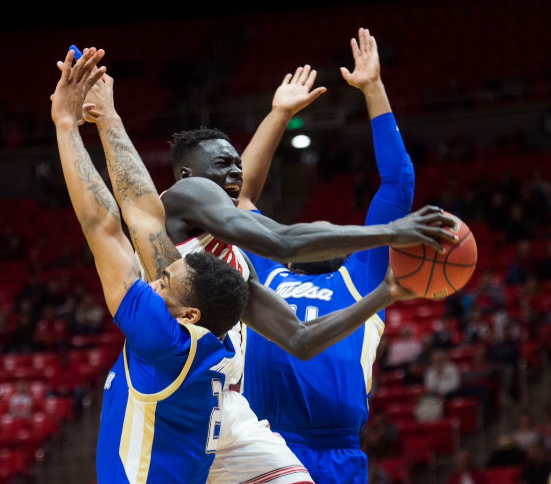 (Rick Egan  |  The Salt Lake Tribune)        Utah Utes forward Both Gach (11) splits his defenders, Tulsa Golden Hurricane guard DaQuan Jeffries (2) and Tulsa Golden Hurricane forward Jeriah Horne (41), in basketball action between, Utah Utes and Tulsa Golden Hurricane, at the Jon M. Huntsman Center, Saturday, Dec. 1, 2018.