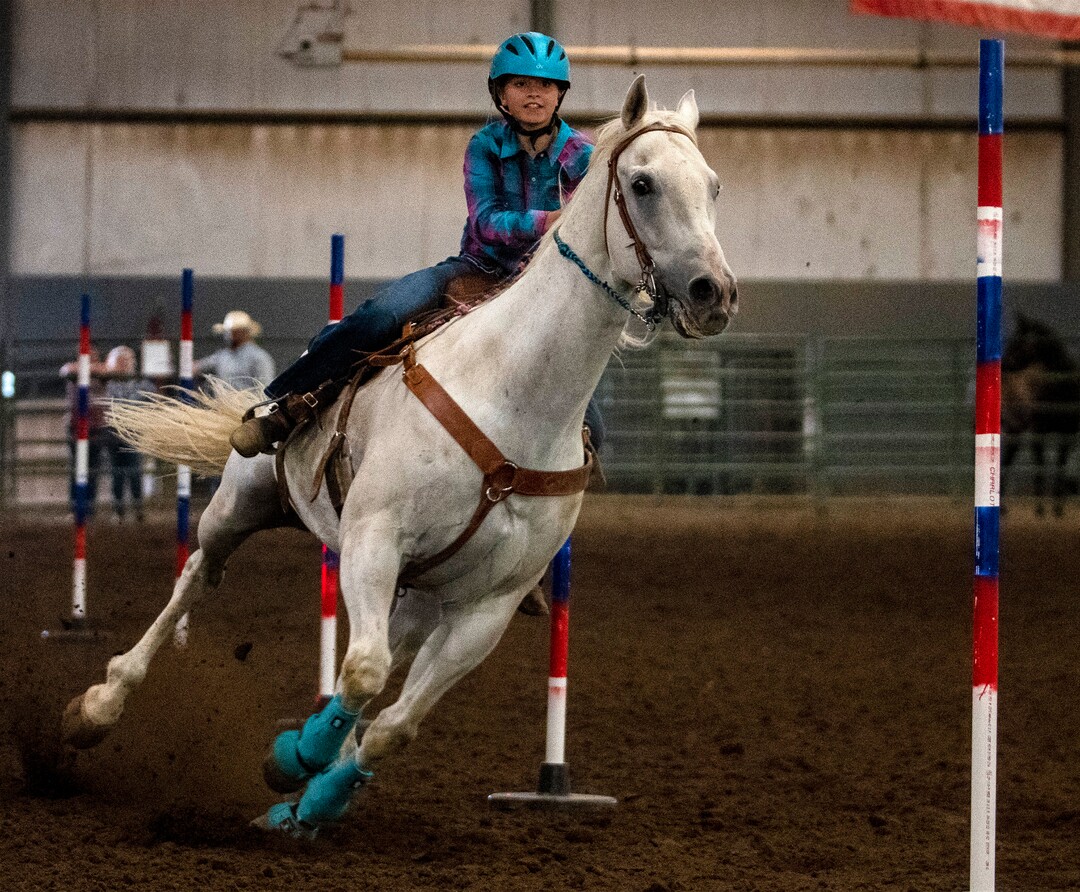 (Rick Egan | The Salt Lake Tribune) Alexa Marshall competes in the pole bending completion at the Panguitch Invitation Rodeo on Saturday, July 23, 2022.