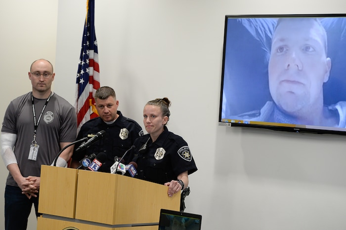 (Francisco Kjolseth  |  The Salt Lake Tribune)  The Kaysville officers that responded to the suicidal subject call on April 5, 2018, and were injured in the fire, speak with the media on Thursday, April 12, 2018. Officer Robert Jackson, 26, recovering at University Hospital burn unit, appears on screen as officer Cade Bradshaw, Sgt. Shawn McKinnon and officer Lacy Turner, from left, answer questions from the media. The four officers were injured when a man at a Chevron gas station store had doused himself with gasoline. As the officers tried to get a lighter from the manÕs hand, the man lit himself on fire.