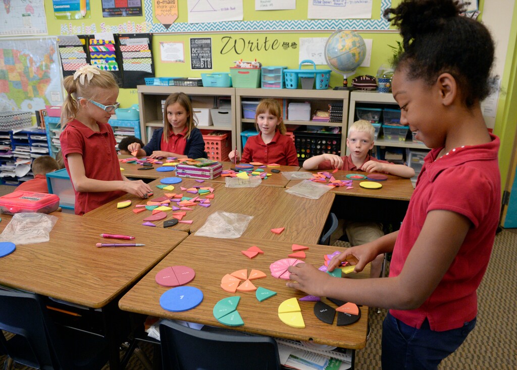 (Al Hartmann  |  Tribune file photo) Maia Rudd, right, use colored shapes to learn fractions in a geometry class at Wasatch Peak Academy in North Salt Lake in 2016.