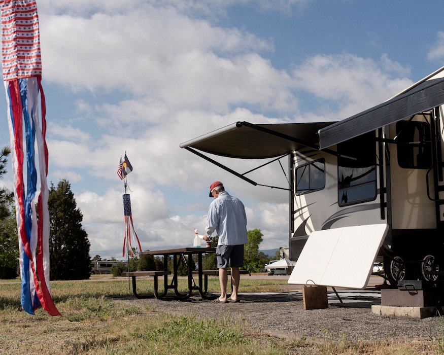 (Benjamin Rasmussen | The New York Times) Packing up an RV in Chatfield State Park outside of Denver, Colo., May 25, 2020. Colorado's state-park campsites are open, at half capacity and requiring advance reservations, while those in Oregon and Washington are closed indefinitely.