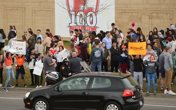 (Leah Hogsten  |  The Salt Lake Tribune) East High School students took to the sidewalk of 13th East to raise awareness and push for change. Exactly one month after 17 people were killed at Marjory Stoneman Douglas High School in Parkland, survivors of the massacre joined tens of thousands of students across the United States by walking out of school,  Wednesday, March 14, 2018. 