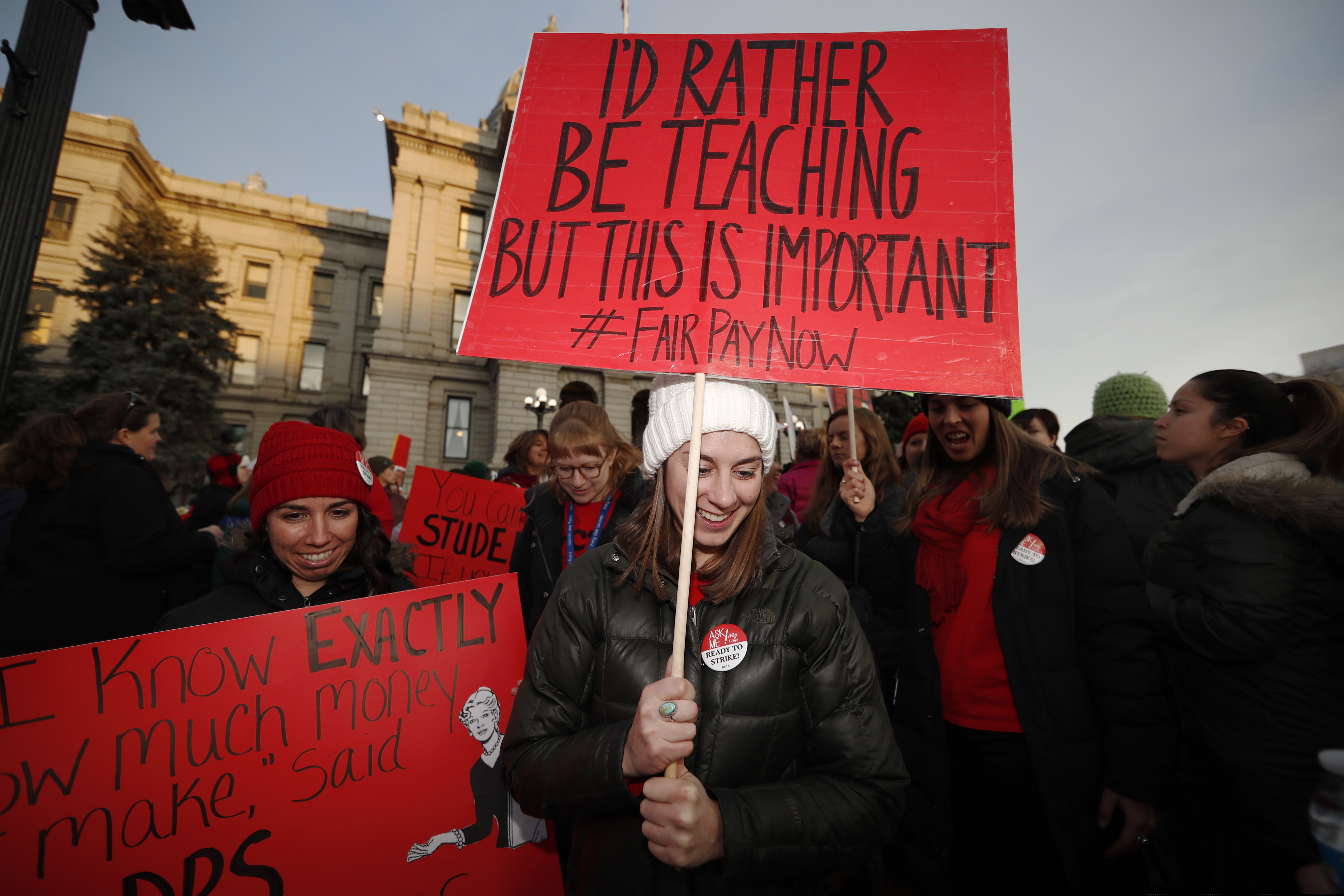 FILE- In this Wednesday, Jan. 30, 2019 file photo, Margaret Flynn, front, a 7th-grade teacher in Denver Public Schools, leads other teachers in a march during a rally outside the state Capitol in Denver. Denver teachers are vowing to walk off the job Monday, Feb. 11, unless they can reach a last-minute pay agreement with school leaders. (AP Photo/David Zalubowski, File)