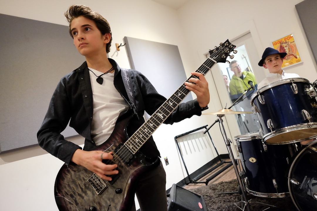 (Francisco Kjolseth  |  The Salt Lake Tribune)  Tega Hamlin, 13, joins other kids in an after school program to jam to rock and roll at MusicGarage.org in Sugarhouse in hopes of joining a kids band to perform at festivals this Summer.