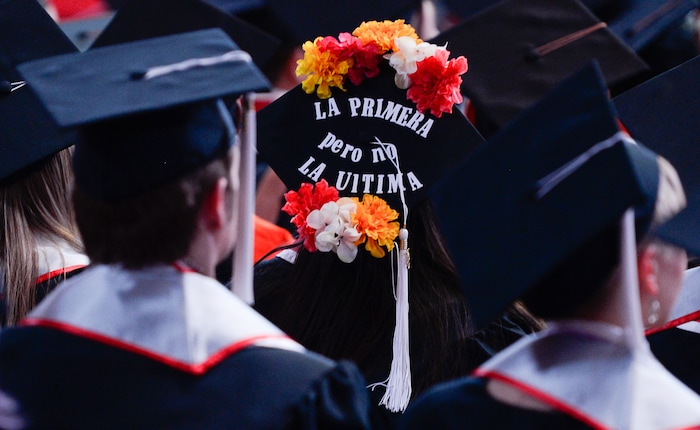 (Francisco Kjolseth  |  The Salt Lake Tribune)  Chiara Padilla who's family immigrated from Uruguay, decorated her mortar board with the words "the first but not the last," becoming the first university graduate in her family as she attends the University of Utah commencement ceremonies on Thursday, May 3, 2018, at the Jon M. Huntsman Center.