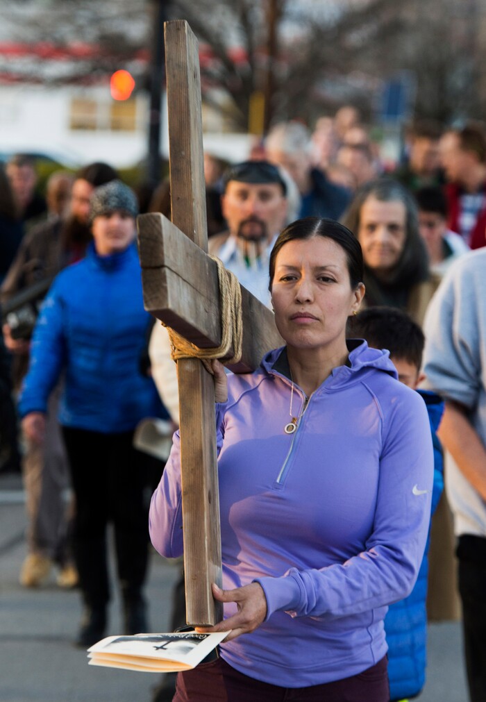 (Rick Egan  |  The Salt Lake Tribune)     Juana DeCasa carries the cross as 
Clergy and members of Christian denominations participate in the annual Good Friday procession through downtown Salt Lake City, Friday, March 30, 2018. The procession commemorating Christ's path to crucifixion has been a tradition of the Salt Lake Council of Churches since 1988. 


