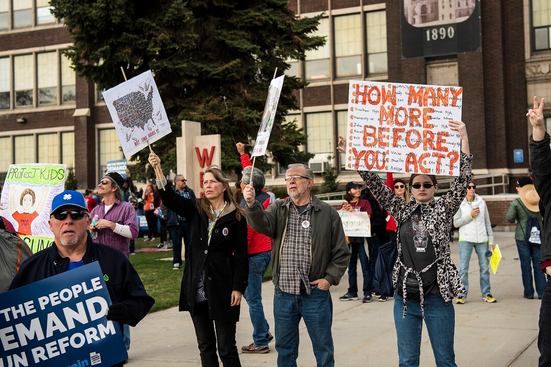 (Chris Detrick | The Salt Lake Tribune)  Participants hold signs as the March Before Our Lives rally walks by during the March for Our Lives rally West High School in Salt Lake City Saturday, March 24, 2018.