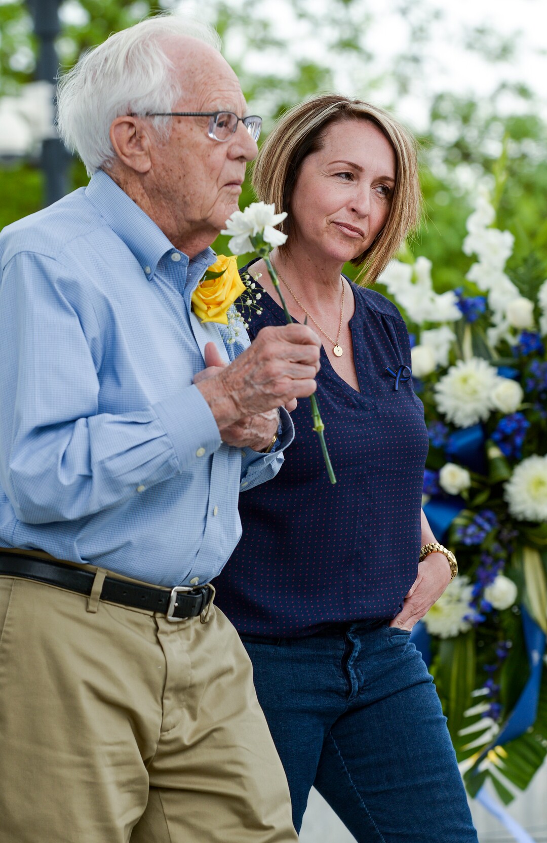 (Leah Hogsten  |  The Salt Lake Tribune) l-r Eldon Lundberg and Shauna Merrill carry a carnation in honor of their grandfather and great-grandfather Officer Thomas F. Griffiths who died in the line of duty in 1913. In honor of Police Week, the Salt Lake City Police Department honored its fallen officers with a memorial service and a 21-gun salute at the Public Safety Building, Thursday, May16, 2019.