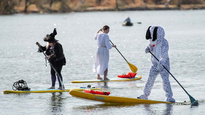 (Francisco Kjolseth  |  The Salt Lake Tribune) Kim Tracy, Miranda Lavallee and Chris Knoles, from left, put their Halloween spirit on the water as they paddle board at Bountiful Pond on Oct. 31, 2020, in what has become a yearly tradition.