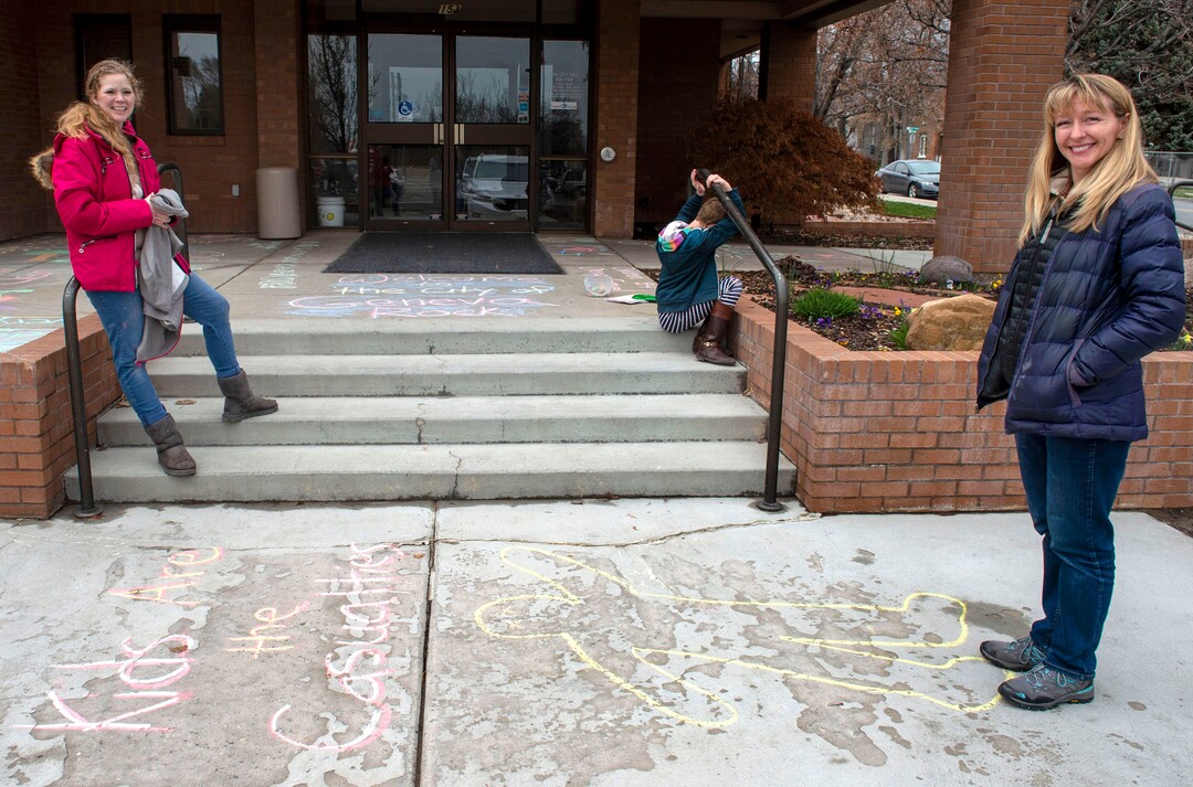 (Rick Egan  |  The Salt Lake Tribune)   Carolyn Hoffert and Angie Parkin and their kids are drawing chalk art on the sidewalk at Lehi City Hall to protest the expansion of Geneva Rock's mining activities near their neighborhood, Tuesday, April 2, 2019.