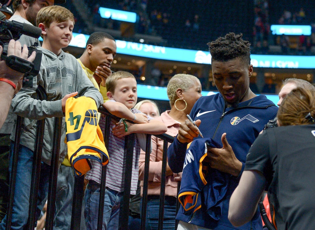 (Leah Hogsten  |  The Salt Lake Tribune)  Utah Jazz guard Donovan Mitchell (45) signs autographs at the end of the game.  The Utah Jazz defeated the Golden State Warriors 119-79 during their game, Tuesday, April 10, 2018 at the Vivant Smart Home Arena. 