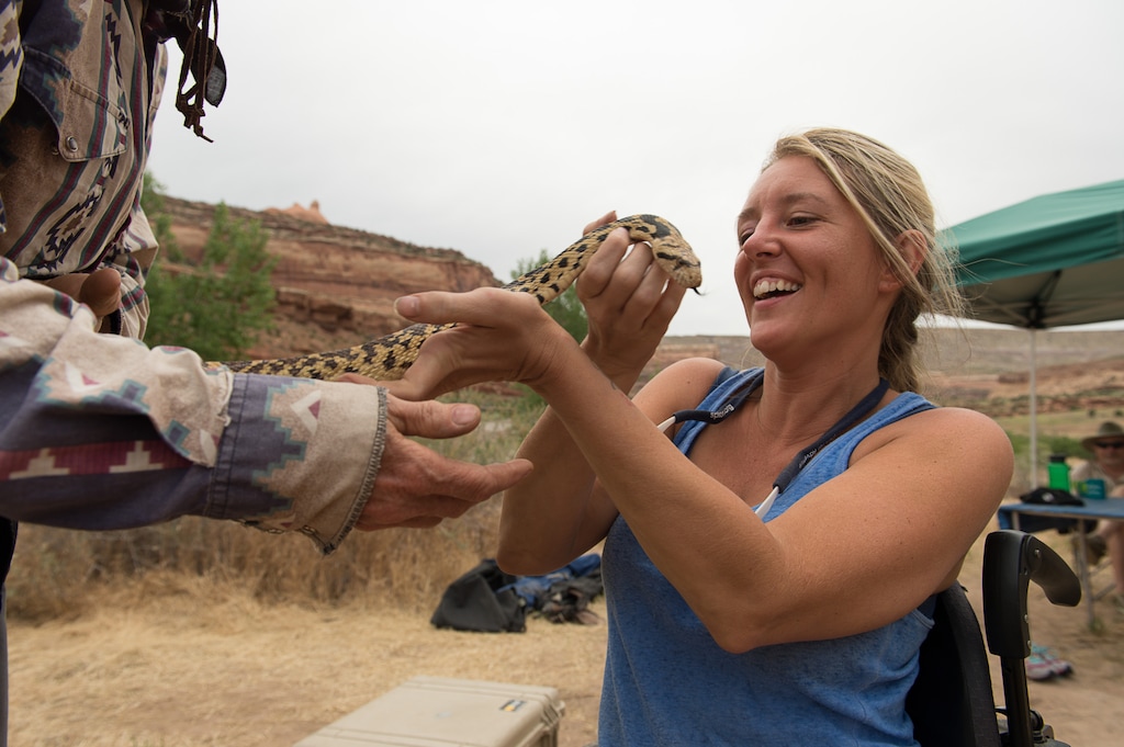 (Francisco Kjolseth | Tribune file photo) Gabrielle Ford of Florida, who is no stranger to the great outdoors, gets an up-close and personal look at a gopher snake during a 2017 trip down the Colorado River with SPLORE, which provides outdoor opportunities to people of all ability levels.