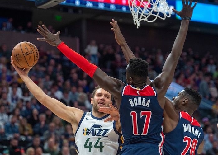 (Rick Egan  |  The Salt Lake Tribune)  Utah Jazz forward Bojan Bogdanovic (44) is double-teamed by Washington Wizards forward Isaac Bonga (17) and Washington Wizards center Ian Mahinmi (28), in NBA action between the Utah Jazz and the Washington Wizards, in Salt Lake City, Friday, February 28, 2020