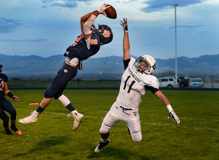 (Scott Sommerdorf  |  The Salt Lake Tribune)  Brighton DB Dylan Pearmain leaps to intercept a pass in the end zone intended for Syracuse WR Dax Harris during second half play. Brighton beat Syracuse 35-14 in a 5A first-round playoff game at Brighton, Friday, October 31, 2014.