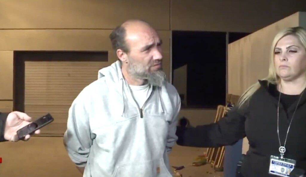 (Screenshot) This still image from a FOX 13 news report shows reporters question Jeffrey Black, who had just been arrested in connection to South Salt Lake Police Officer David Romrell's death. Black was being taken from the Salt Lake County Sheriff's Office to the county jail on Monday, Nov. 26.