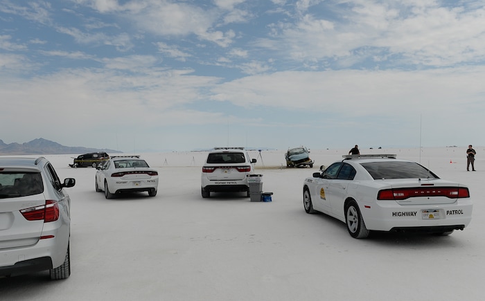 (Francisco Kjolseth | The Salt Lake Tribune) Highway patrol investigate the scene of a deadly crash at Utah's Bonneville Salt Flats along the sidelines of Speed Week following a head-on collision between two vehicles carrying support crew traveling between the pits and the entrance to the salt along the access road on Wednesday, Aug. 16, 2017. One person was killed and five injured, all of whom were said to be members of support crews for racing drivers.