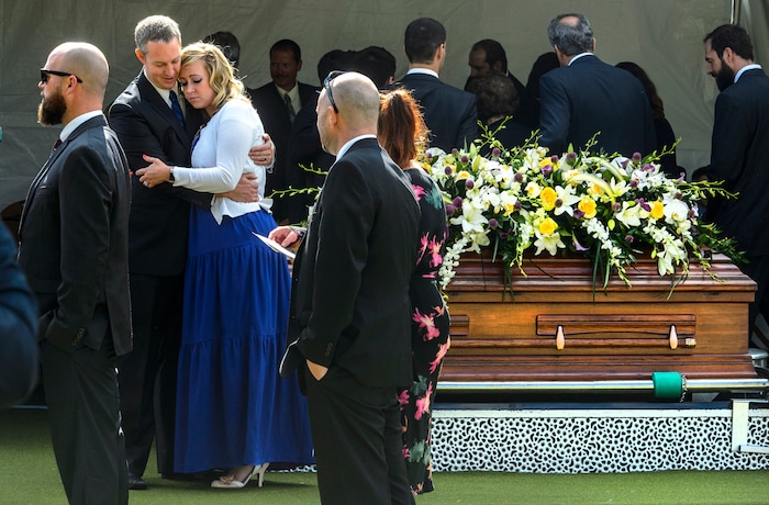 (Steve Griffin  |  The Salt Lake Tribune)  Emilie Johnson is consoled by her husband, Riley Johnson, as they stand with the casket following graveside services for Elder Robert D Hales at the Bountiful City Cemetery in Bountiful Friday October 6, 2017.
