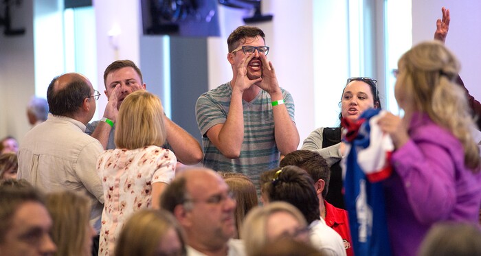 Leah Hogsten | The Salt Lake Tribune
During Saturday's stump speech by Republican Sen. Ted Cruz, protestors who criticize Cruz's vote to repeal the Affordable Care Act are shouted down and removed from the rally for 3rd District primary candidate, former state Rep. Chris Herrod, June 29, 2017 at Entrata in Lehi.